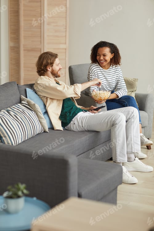 Preview: Cheerful Couple Watching TV at Home