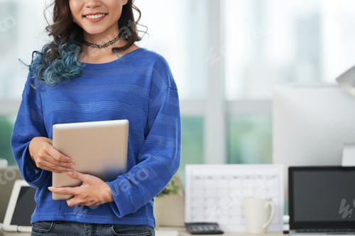 Preview: Crop woman with tablet in office