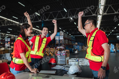 Preview: Group warehouse workers stack hand to celebrate and be happy in the warehouse.