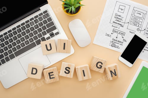 Preview: top view of gadgets near wooden blocks with ui design lettering, website design template and green