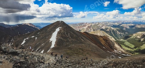Preview: Hikers on a scenic mountain trail in the Rockies.