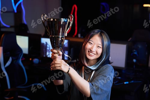Preview: Young Asian Woman Celebrating Victory in Cybersports Tournament