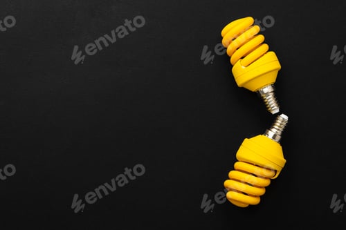 Preview: Yellow light bulbs on black background top view