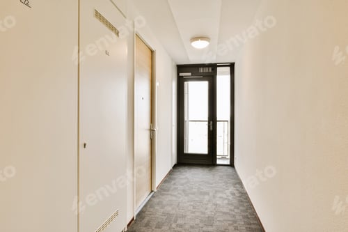 Preview: a hallway with white walls and doors and a carpet