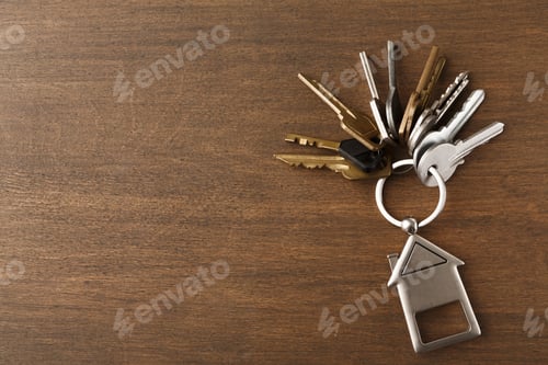 Preview: Bunch of keys with house shaped keychain on white wood
