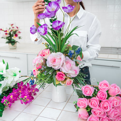 Preview: Arranging artificial flowers decoration at home, Young woman flo