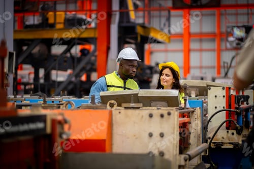 Preview: Team male and female engineers in a metal sheet factory