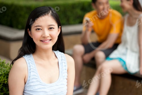 Preview: Portrait of a young woman, friends in background