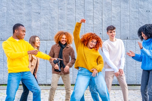 Preview: Friends celebrating and dancing in the street