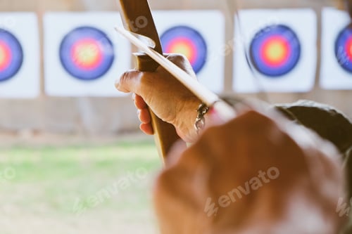 Preview: Archer holds his bow aiming at a target