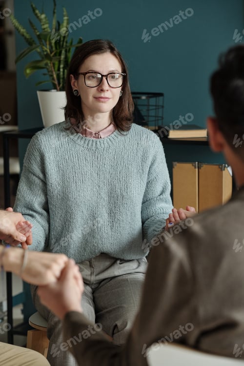 Preview: Young Woman Participating in Group Therapy Session Indoors