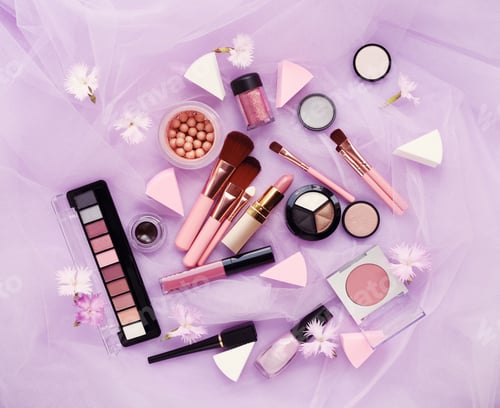 Preview: Makeup brush and decorative cosmetics with flowers on a pink vei