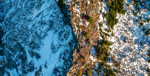 Preview: Rocky Mountain peak covered in Snow. Sunny Sunset. Aerial.