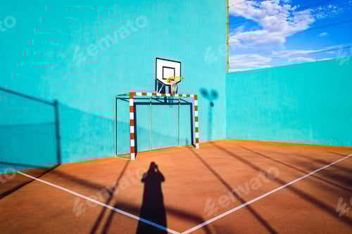 Preview: Wall with goal and basketball court for summer sports, blue tones, outdoors.