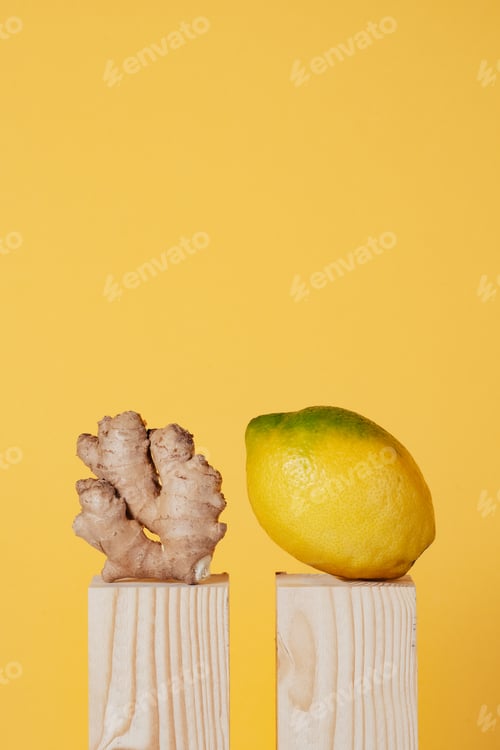 Preview: lemon and ginger on wooden pedestal on yellow background