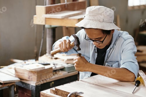 Preview: Carpenter working with chisel