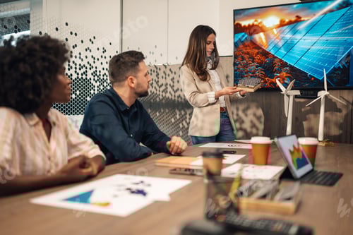 Preview: Businesswoman with solar panels model having presentation at boardroom