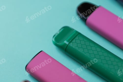 Preview: Colorful disposable vape devices on a green background, symbolizing unhealthy lifestyle choices