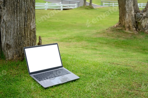 Preview: Laptop with blank screen on green grass, for outdoor workspace and digital mockups