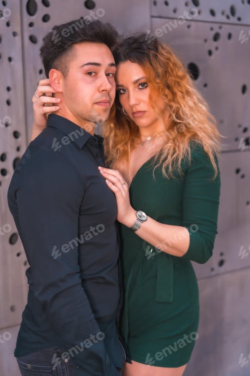 Preview: Fashionable pose of a Caucasian couple in a blue suit and green dress