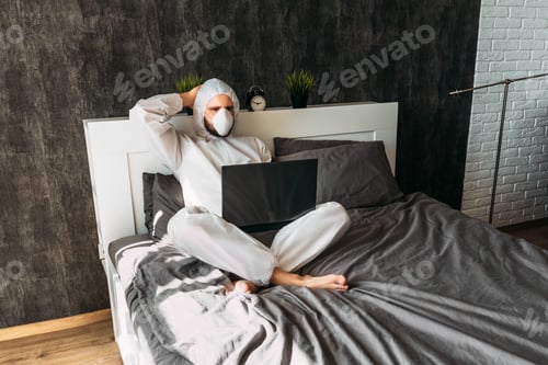 Preview: Person Relaxing in Bed Wearing Hazmat Suit