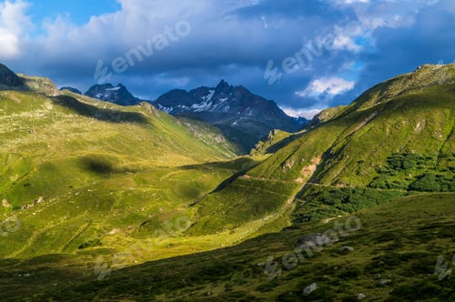 Preview: Landscape of mountains covered in greenery under the sunlight in Tyrol