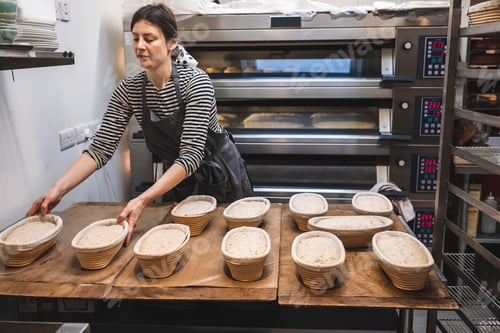 Preview: A baker in an artisan bakery making sourdough bread.