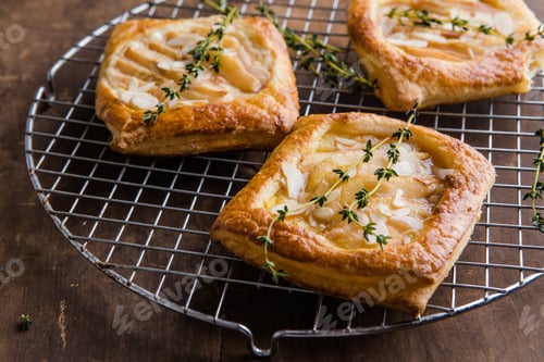 Preview: Golden baked pear wrapped in flaky puff pastry, served as elegant dessert
