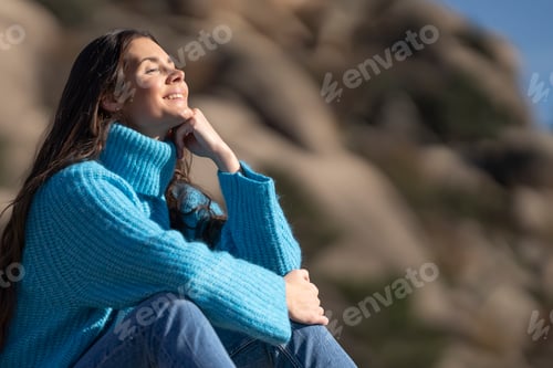 Preview: Side portrait of happy woman resting and breathing fresh air in high mountains