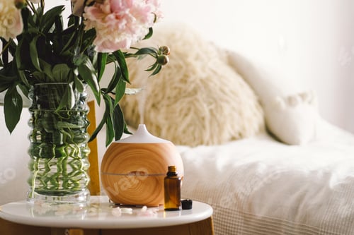 Preview: Aroma oil diffuser on chair against in the bedroom. Air freshener.