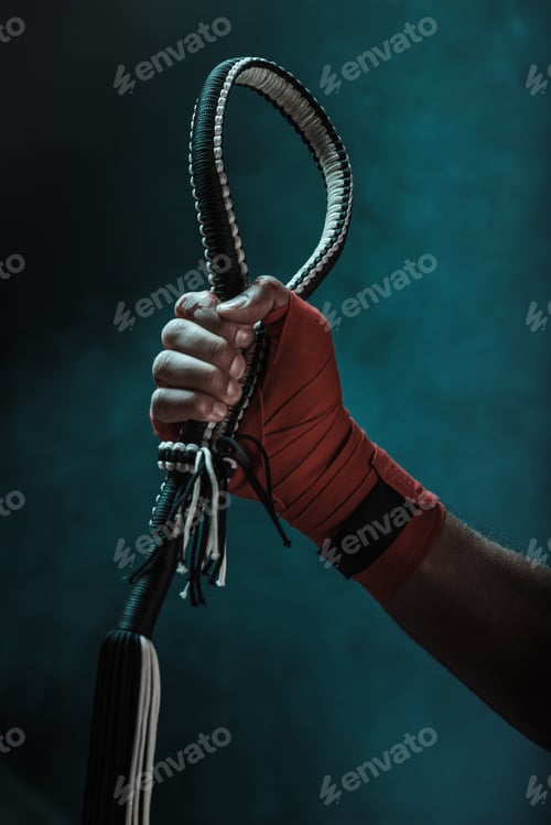 Preview: Close-up partial view of muay thai fighter holding mongkhon, action sport concept