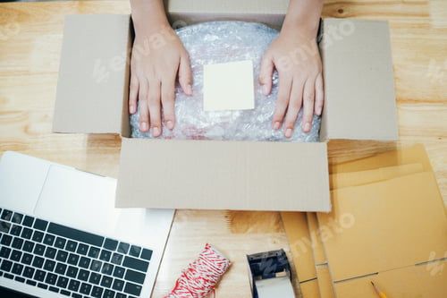 Preview: Online business owner preparing product to customer.
