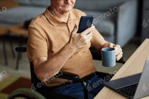 Preview: Senior man with disability using smartphone