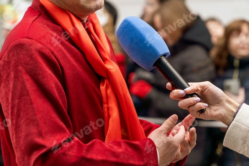 Preview: Television reporter with microphone in an interview for the news