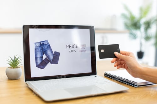 Preview: Caucasian woman shopping online with credit card and laptop