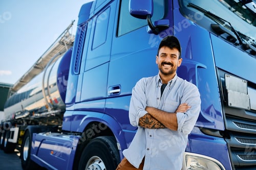 Preview: Happy professional truck driver with crossed arms looking at camera.