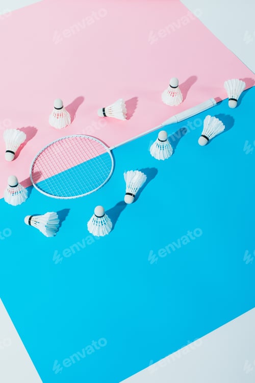 Preview: shuttlecocks around badminton racket on blue and pink papers