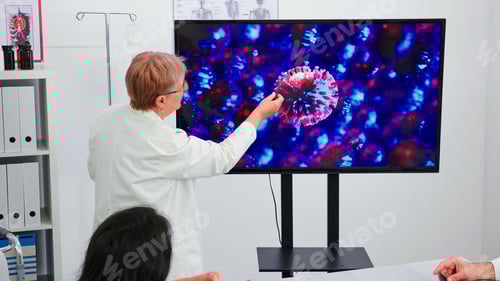 Preview: Medical specialist talking about vaccine for coronavirus using monitor