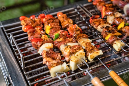Preview: Barbeque skewers meat with vegetable grilling on charcoal bbq grill in backyard