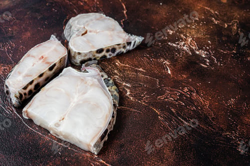 Preview: Raw atlantic wolffish fish Steak. Dark background. Top view. Copy space
