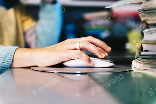 Preview: closeup of a female hand clicking computer mouse