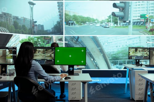 Preview: Indian woman working with CCTV footage and greenscreen on computers