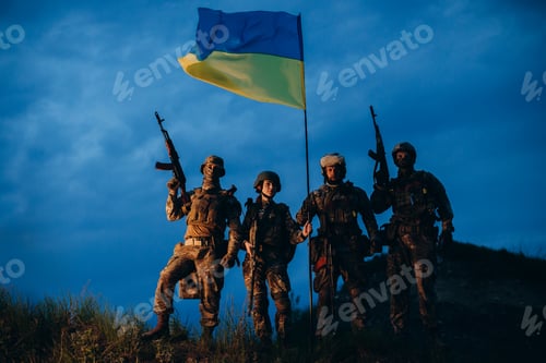 Preview: Portrait of Ukrainian armed forces with a national flag in the evening posing for camera