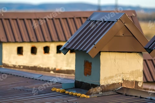 Preview: Close-up of a new built chimney on a house roof under construction