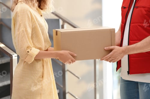 Preview: Woman receiving parcel from deliveryman on blurred background, closeup. Space for text