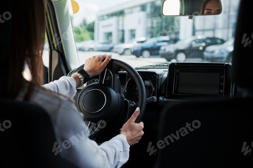 Preview: Particle view of woman that drives modern new car in the city