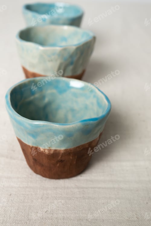 Preview: Close-up blue brown handmade ceramic cups, vertical