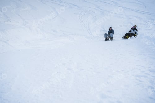 Preview: Crazy happy friends having fun with sledding on snow high mountains