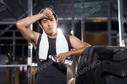 Preview: Young man resting at gym