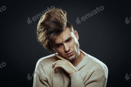 Preview: Handsome man with modern hairstyle in studio